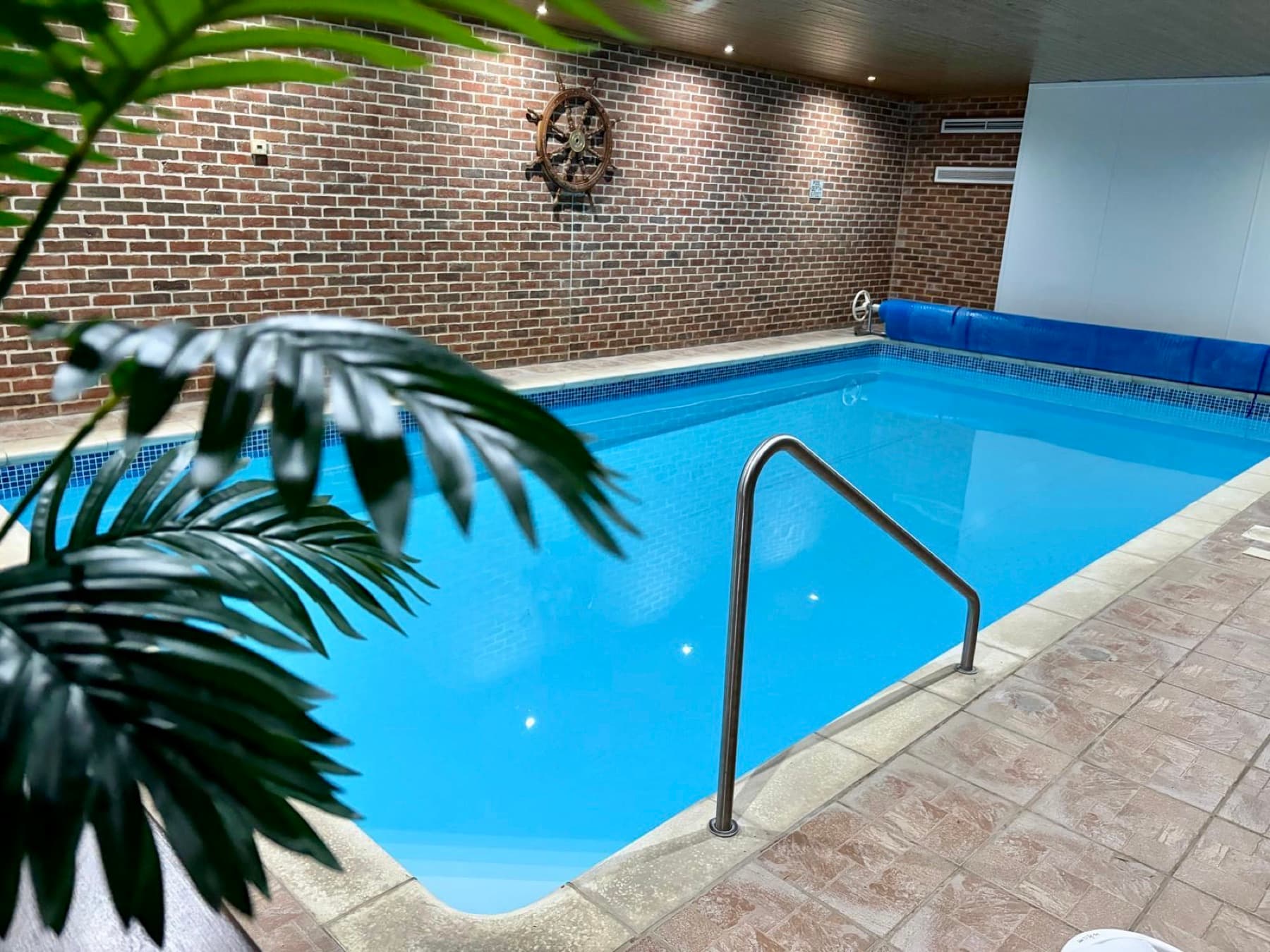Indoor heated swimming pool with exposed brick walls